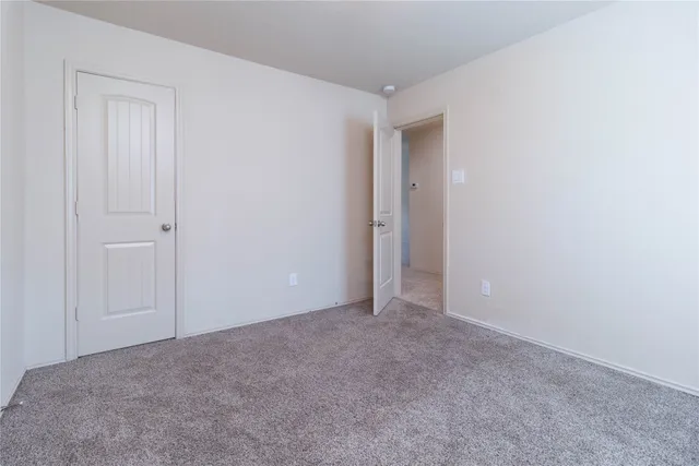 a view of an empty room and closet area
