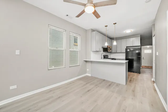 a large kitchen with kitchen island a sink stainless steel appliances and cabinets