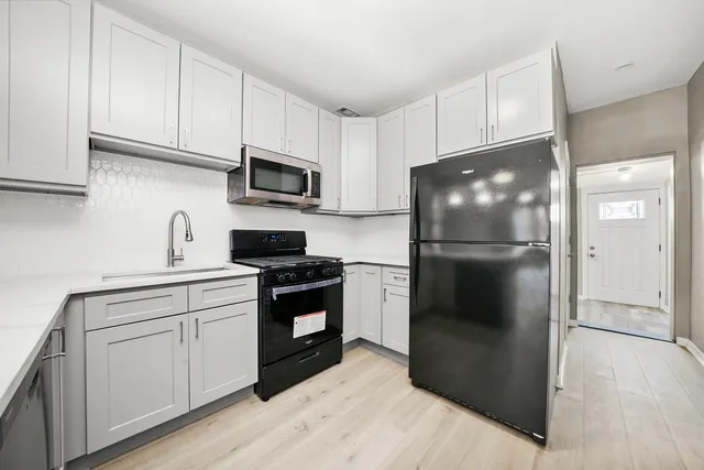 a kitchen with stainless steel appliances a refrigerator stove and sink