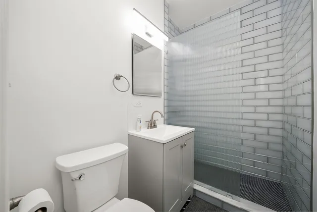 a bathroom with a sink a toilet and mirror