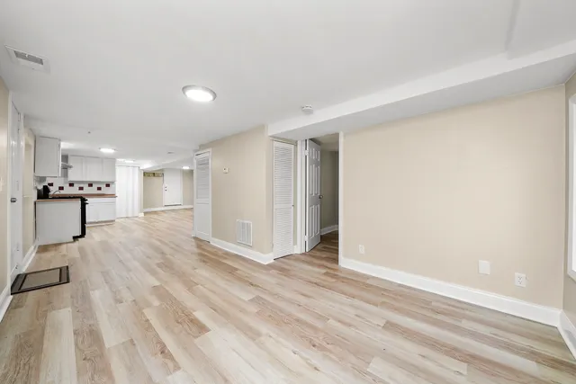 a view of a kitchen with a sink and a refrigerator