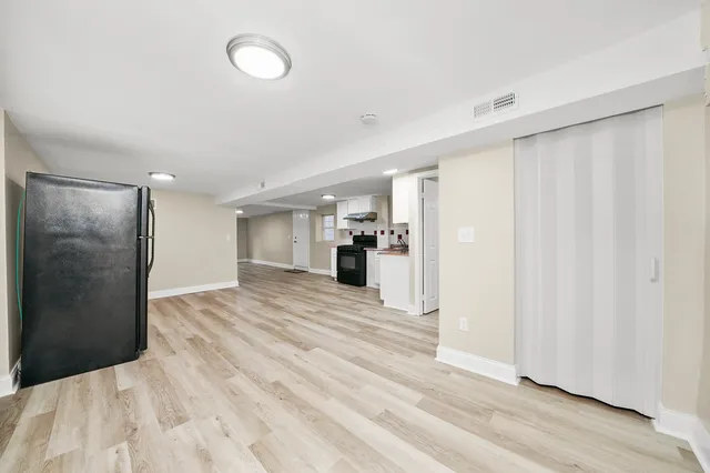 a view of a bedroom with wooden floor and closet