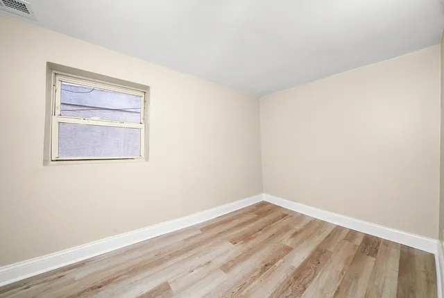 a view of a room with wooden floor and wall painting