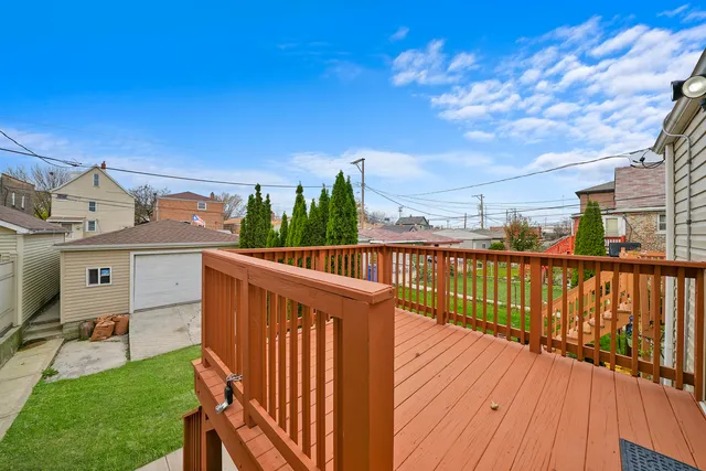 a view of a deck with two chair and a floor to ceiling window
