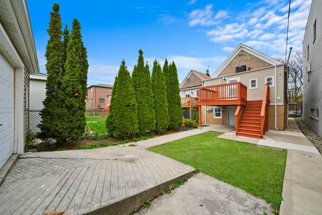 a front view of a house with a yard and trees