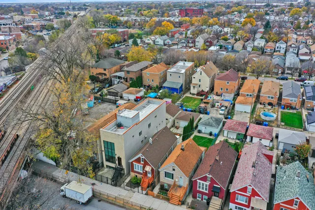 an aerial view of residential houses with outdoor space