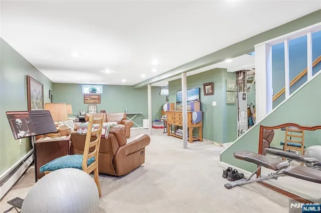 a living room with furniture gym equipment and a window