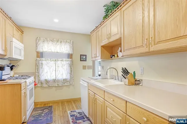 a kitchen with a sink a window and cabinets