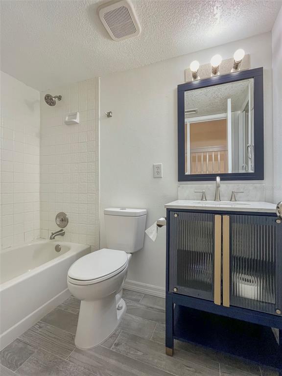 4001 South Beneva Road, Unit 416 Sarasota, FL 34233 - Photo 11 of 19 a bathroom with a sink toilet a mirror and bathtub