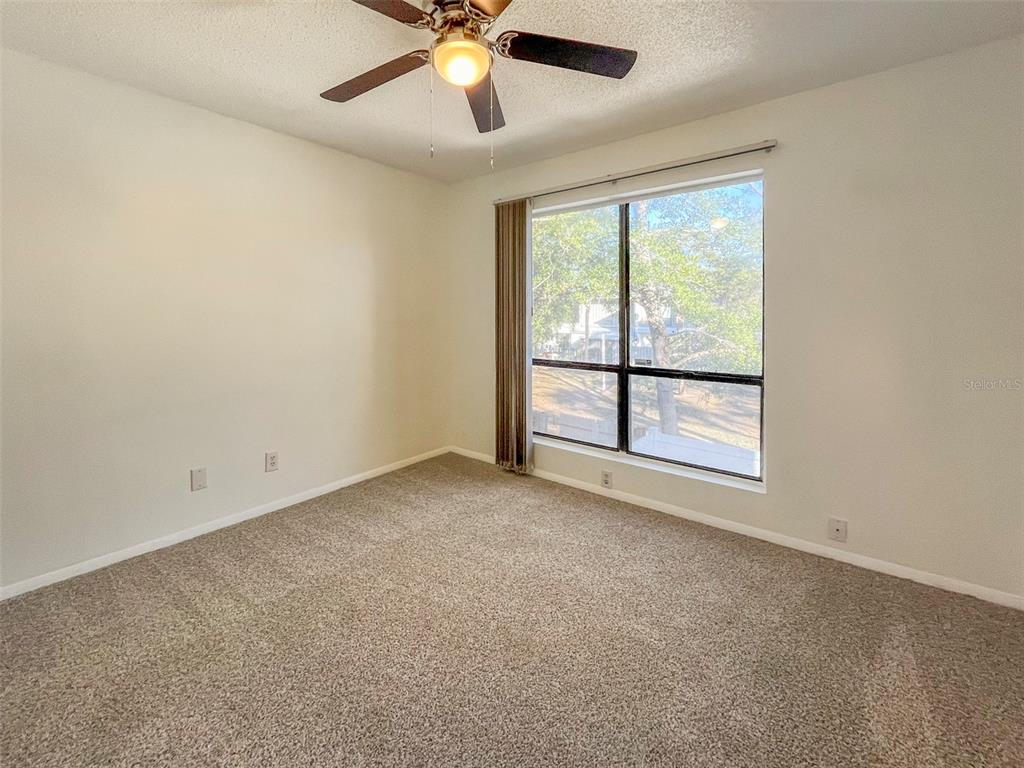 4001 South Beneva Road, Unit 416 Sarasota, FL 34233 - Photo 12 of 19 an empty room with a window and a ceiling fan