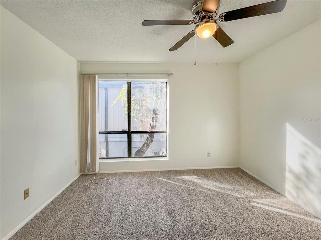 4001 South Beneva Road, Unit 416 Sarasota, FL 34233 - Photo 14 of 19 an empty room with a window and a fan