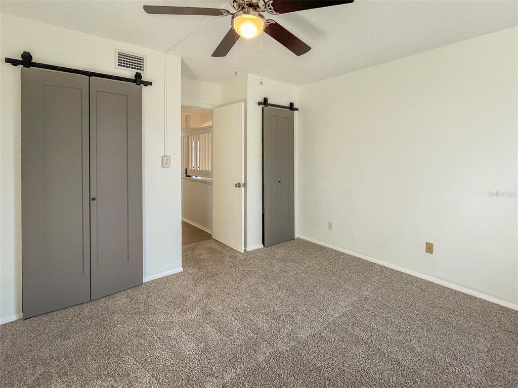 4001 South Beneva Road, Unit 416 Sarasota, FL 34233 - Photo 15 of 19 an empty room with a ceiling fan and closet