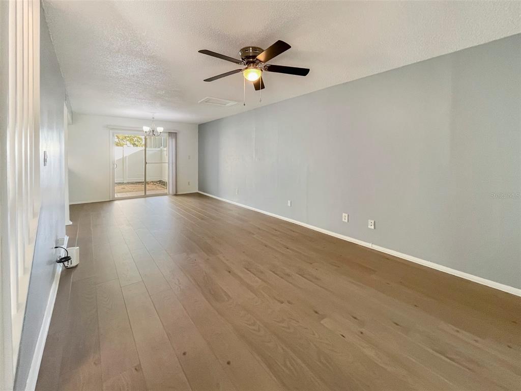 4001 South Beneva Road, Unit 416 Sarasota, FL 34233 - Photo 3 of 19 an empty room with wooden floor and windows