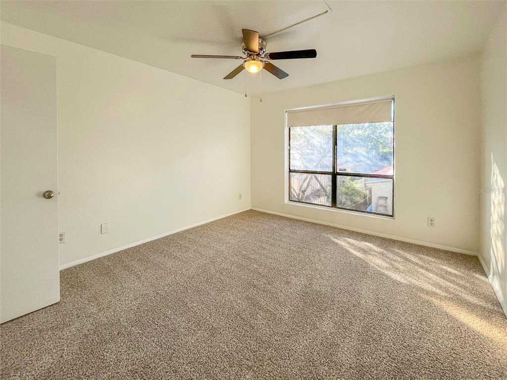 4001 South Beneva Road, Unit 416 Sarasota, FL 34233 - Photo 6 of 19 an empty room with windows and ceiling fan