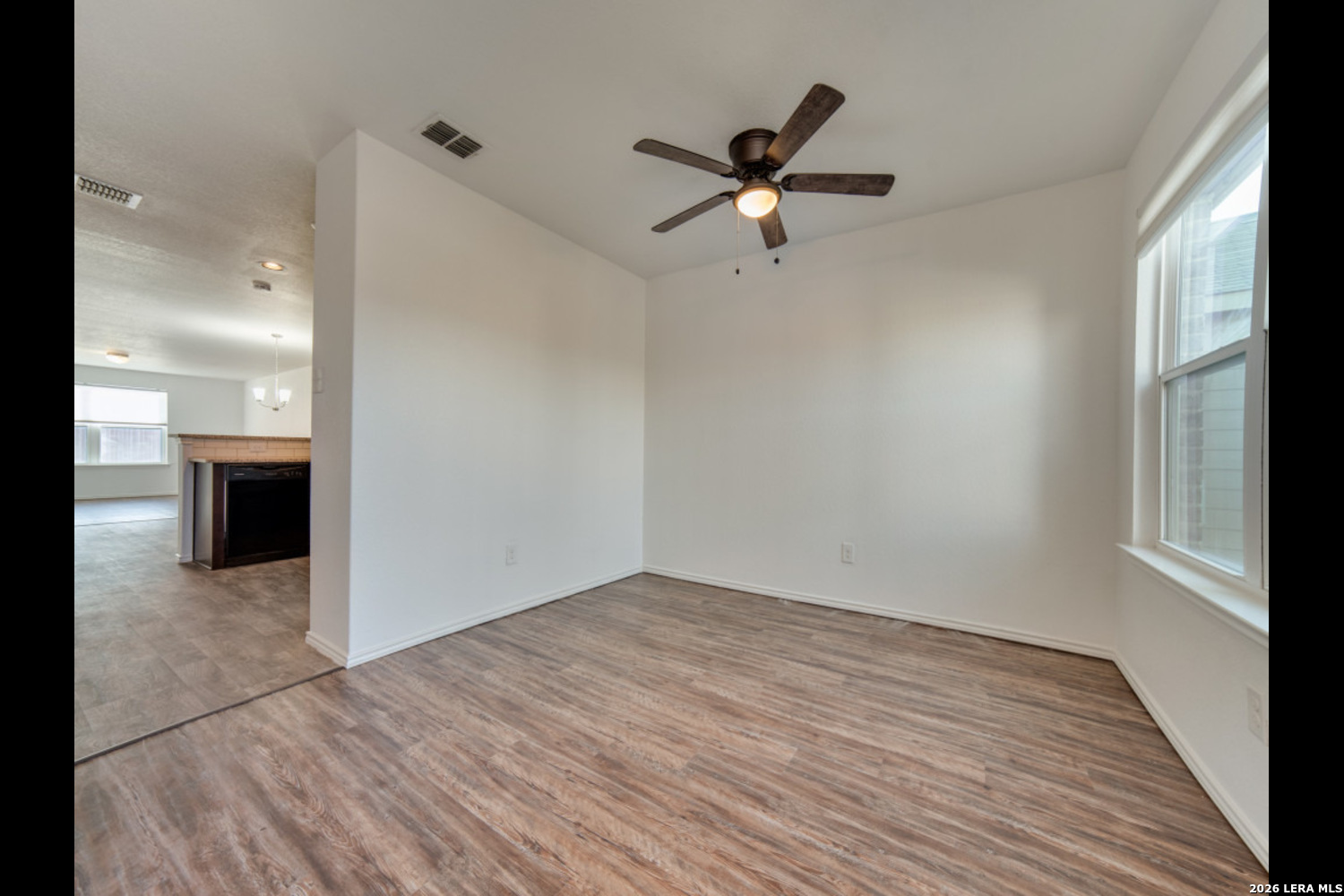 2426 Rainbow Basin Converse, TX 78109 - Photo 3 of 12 a view of empty room with wooden floor and window