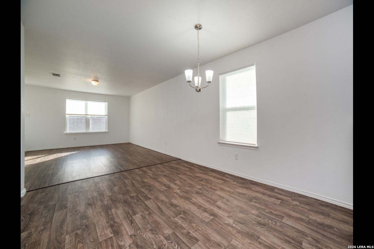 2426 Rainbow Basin Converse, TX 78109 - Photo 8 of 12 an empty room with wooden floor and windows
