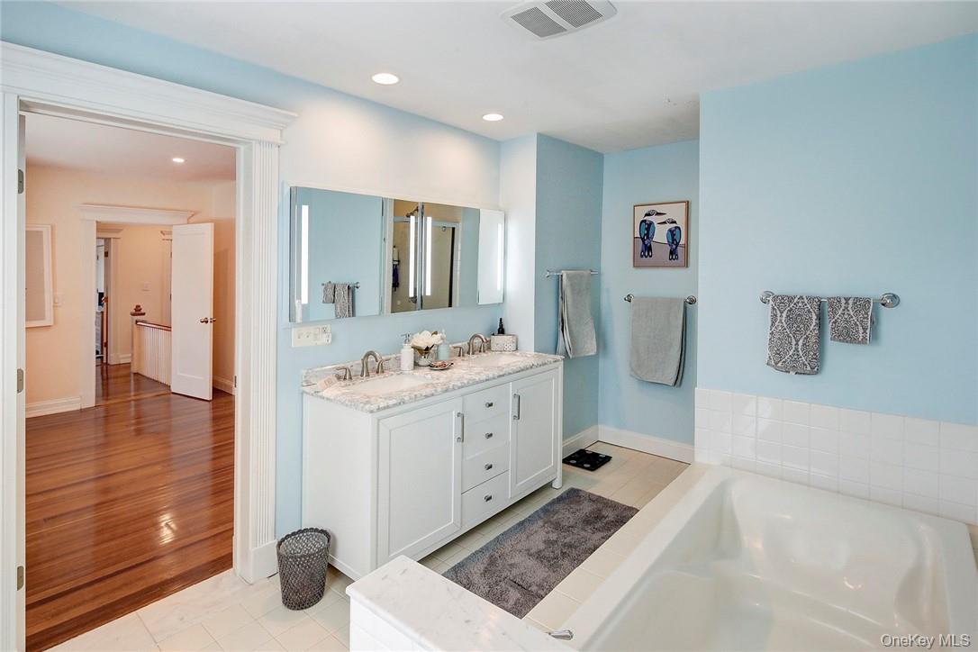 8 Horton Street Rye, NY 10580 - Photo 12 of 24 Renovated Primary Bathroom featuring double vanity, a garden tub, shower and recessed lighting,