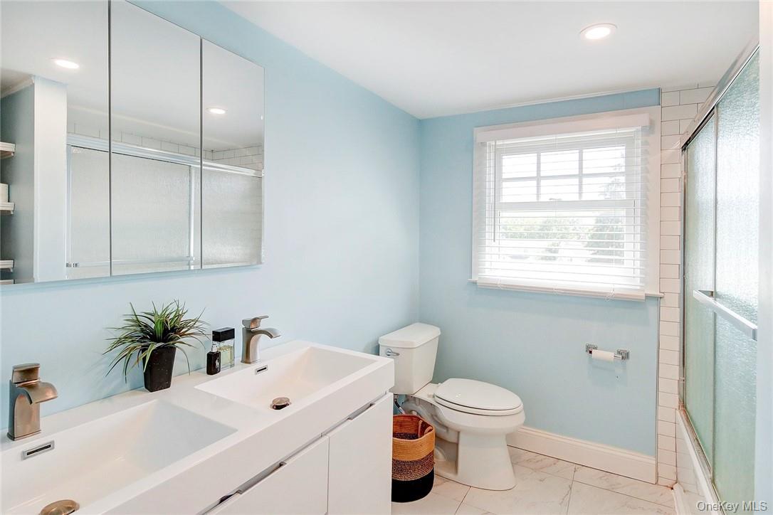 8 Horton Street Rye, NY 10580 - Photo 15 of 24 Full updated bathroom with double vanity, recessed lighting, and enclosed tub / shower combo