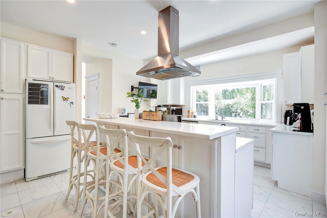 8 Horton Street Rye, NY 10580 - Photo 5 of 24 Renovated Kitchen with seating at island, white cabinetry, and light marble finish flooring