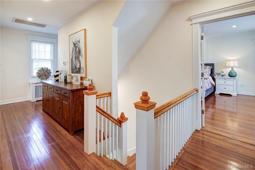 8 Horton Street Rye, NY 10580 - Photo 10 of 24 Hallway featuring hardwood floors, an upstairs landing, and recessed lighting