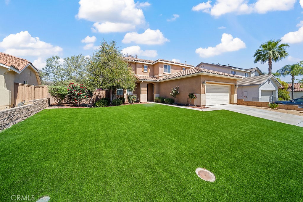 7606 Isla Street Hemet, CA 92545 - Photo 1 of 41 a view of a house with a big yard and potted plants