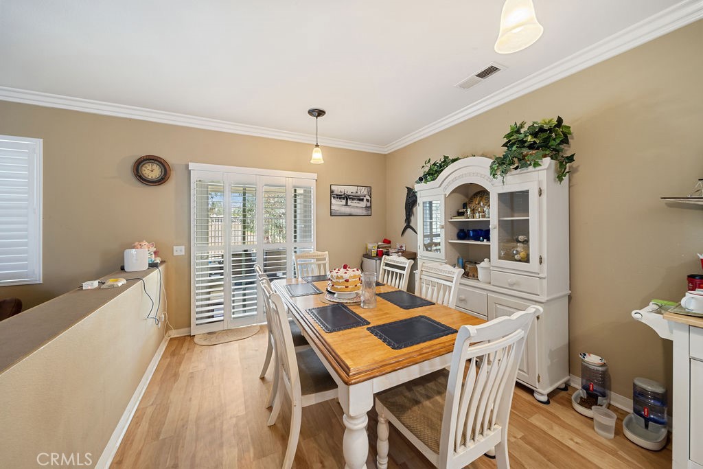 7606 Isla Street Hemet, CA 92545 - Photo 11 of 41 a view of a dining room with furniture and wooden floor