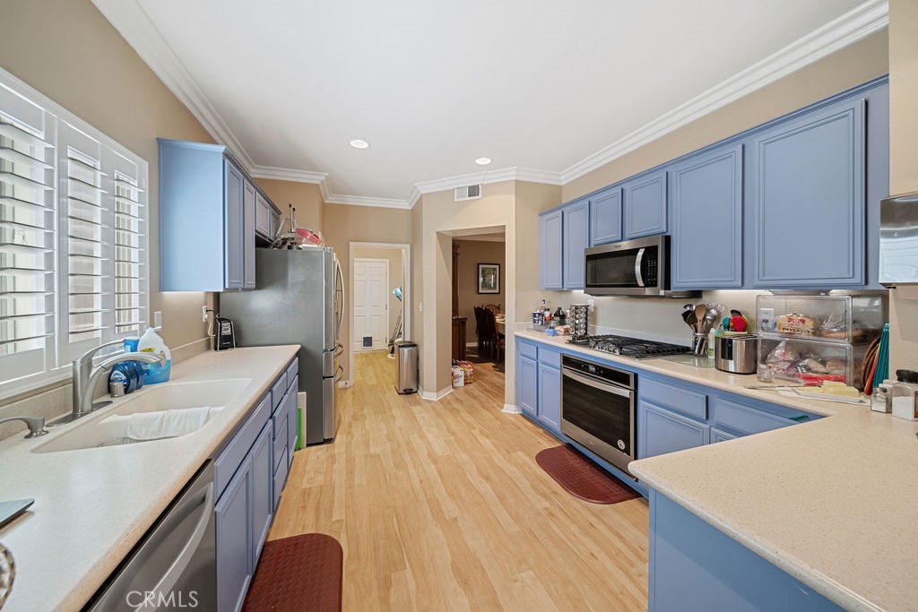 7606 Isla Street Hemet, CA 92545 - Photo 13 of 41 a kitchen with stainless steel appliances granite countertop a sink dishwasher stove top oven and refrigerator