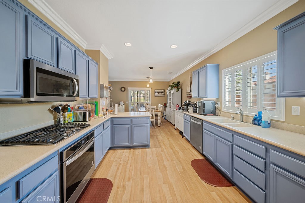 7606 Isla Street Hemet, CA 92545 - Photo 14 of 41 a kitchen with granite countertop a sink a counter space appliances and cabinets
