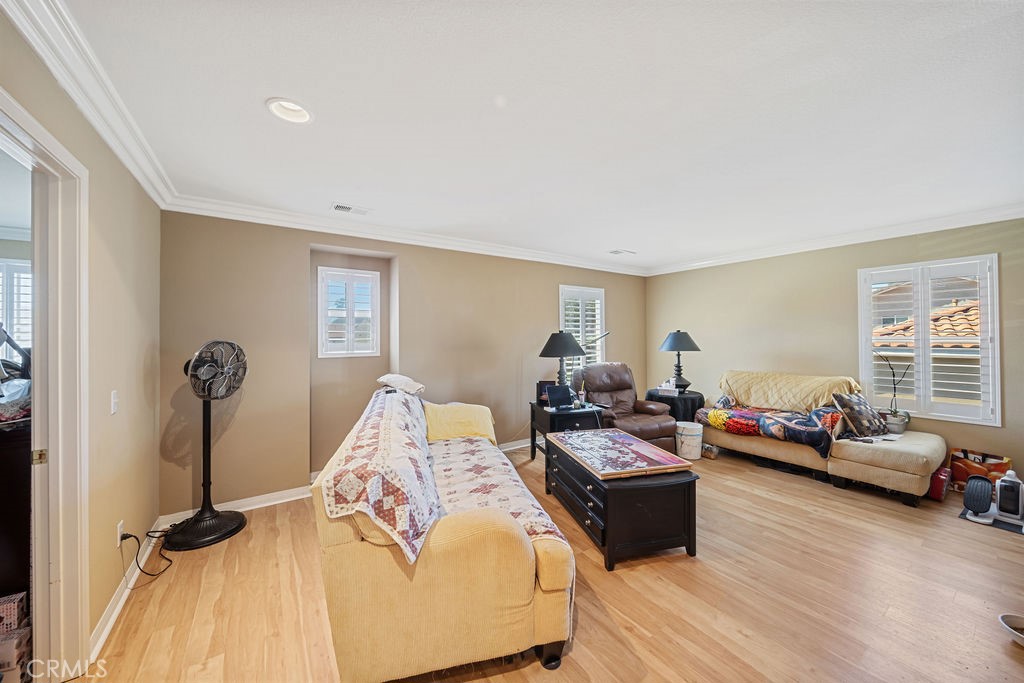 7606 Isla Street Hemet, CA 92545 - Photo 15 of 41 a bedroom with furniture and a wooden floor