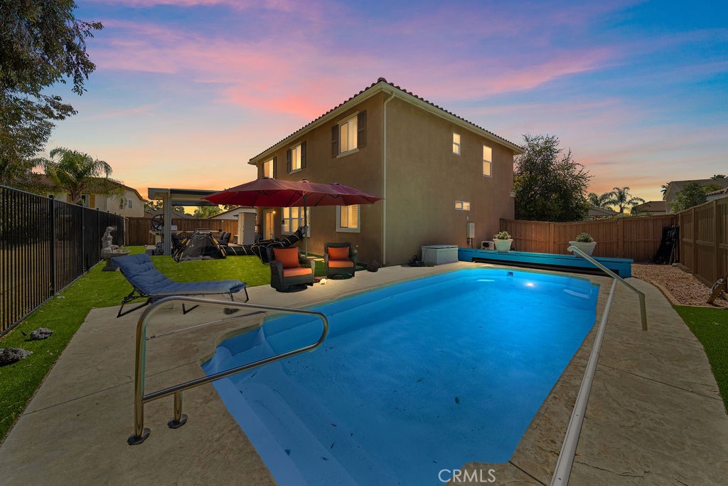 7606 Isla Street Hemet, CA 92545 - Photo 2 of 41 a view of swimming pool with outdoor seating and a yard