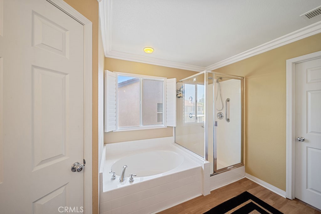 7606 Isla Street Hemet, CA 92545 - Photo 21 of 41 a bathroom with a bathtub and a shower