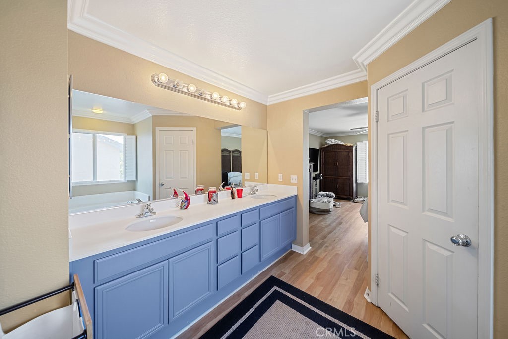 7606 Isla Street Hemet, CA 92545 - Photo 22 of 41 a en suite bathroom with a double vanity sink and mirror