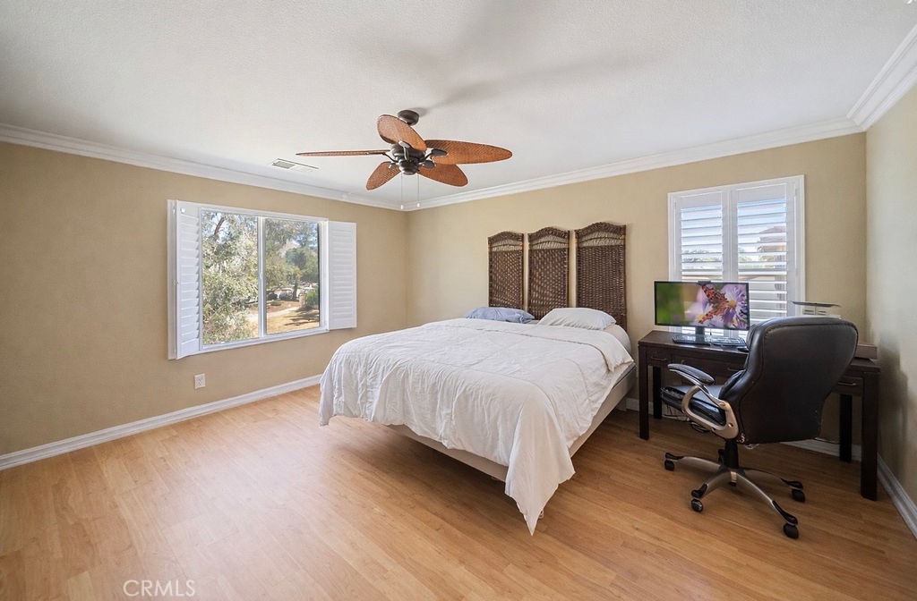 7606 Isla Street Hemet, CA 92545 - Photo 25 of 41 a bedroom with a large bed and wooden floor