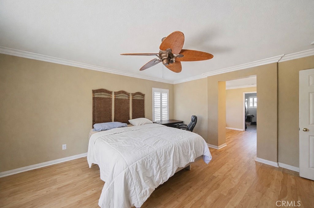 7606 Isla Street Hemet, CA 92545 - Photo 26 of 41 a bedroom with a bed and a chandelier