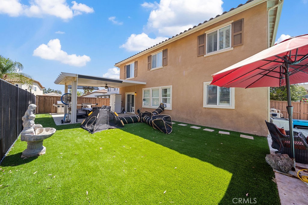 7606 Isla Street Hemet, CA 92545 - Photo 29 of 41 a view of a house with backyard sitting area and garden
