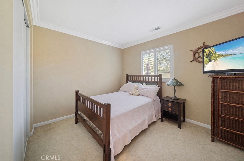 7606 Isla Street Hemet, CA 92545 - Photo 10 of 41 a bedroom with a bed and a window