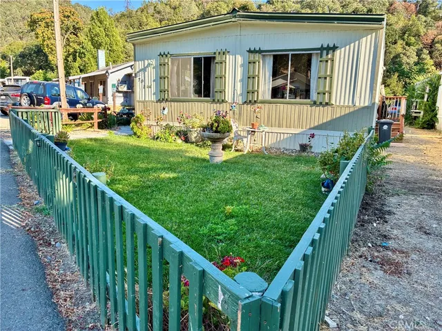 a view of house with yard in front of it