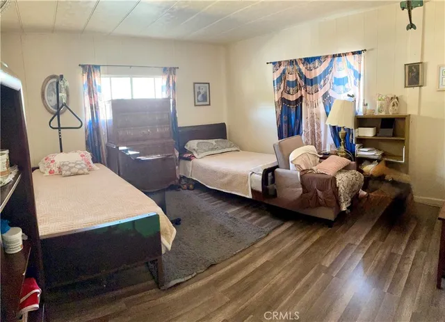 a bedroom with two beds and a window