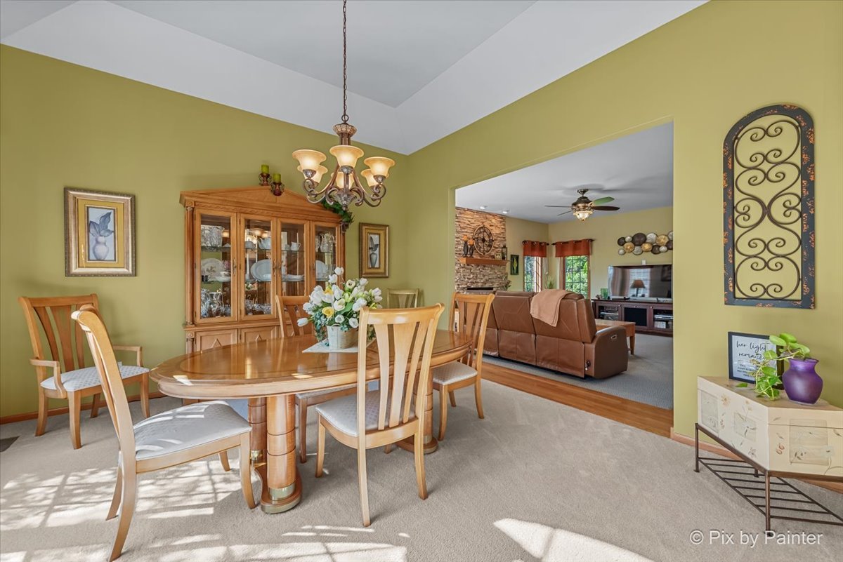 3720 Cypress Drive Spring Grove, IL 60071 - Photo 11 of 55 a view of a dining room with furniture and chandelier