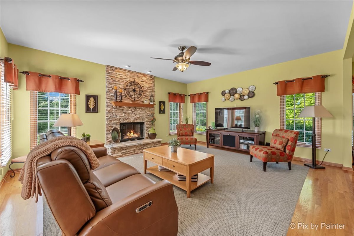 3720 Cypress Drive Spring Grove, IL 60071 - Photo 12 of 55 a living room with furniture ceiling fan and a fireplace