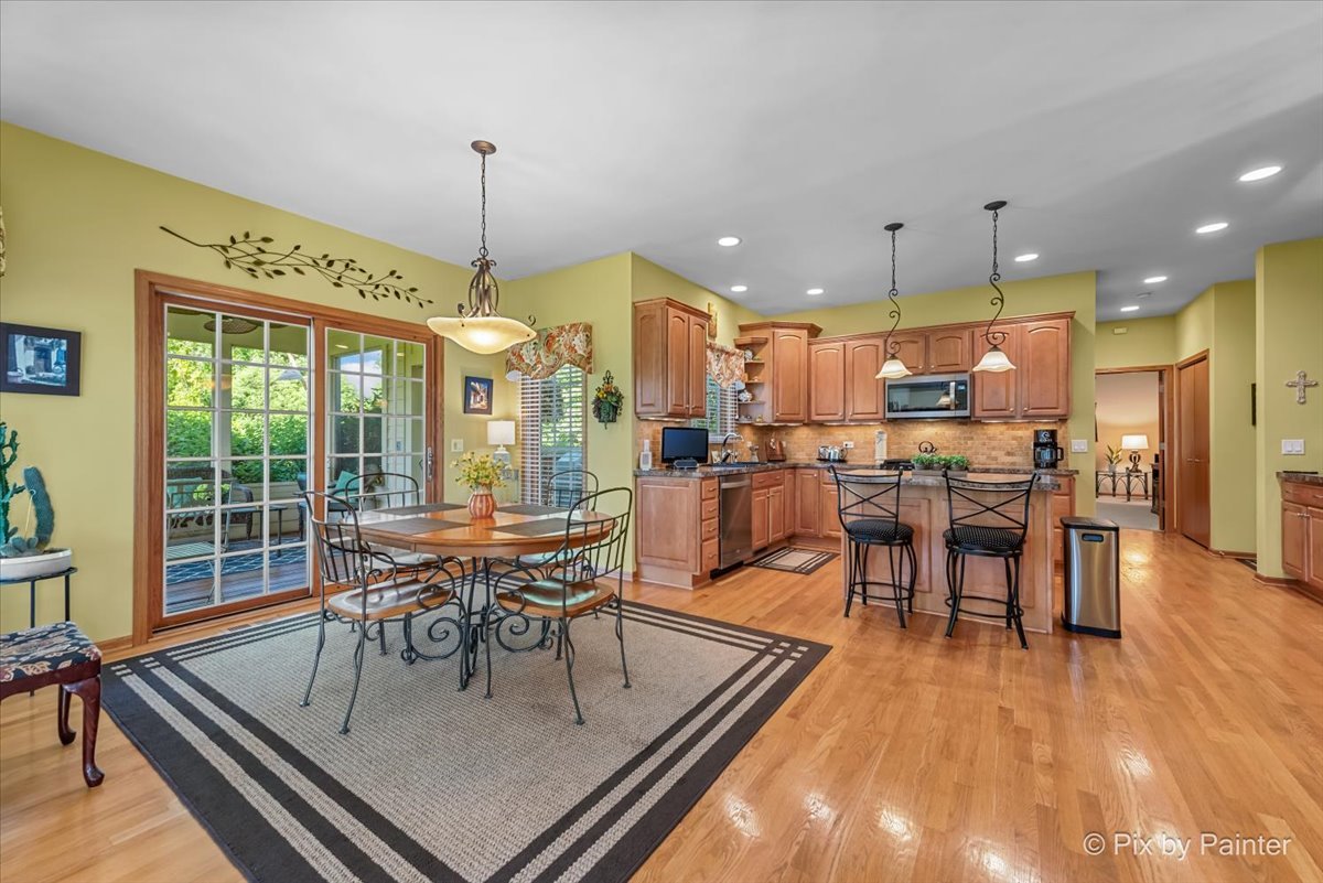 3720 Cypress Drive Spring Grove, IL 60071 - Photo 13 of 55 a dining room with furniture a chandelier and wooden floor