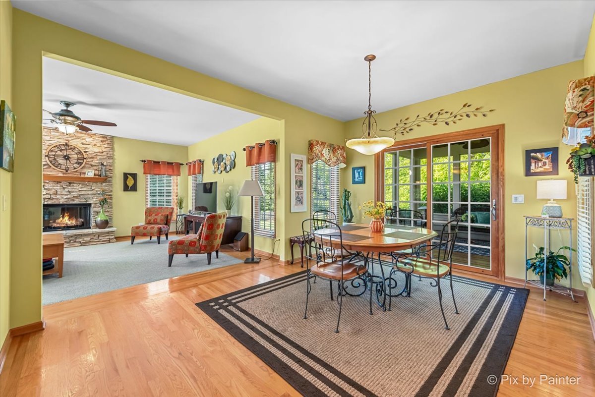 3720 Cypress Drive Spring Grove, IL 60071 - Photo 14 of 55 a dining room with furniture a chandelier and wooden floor