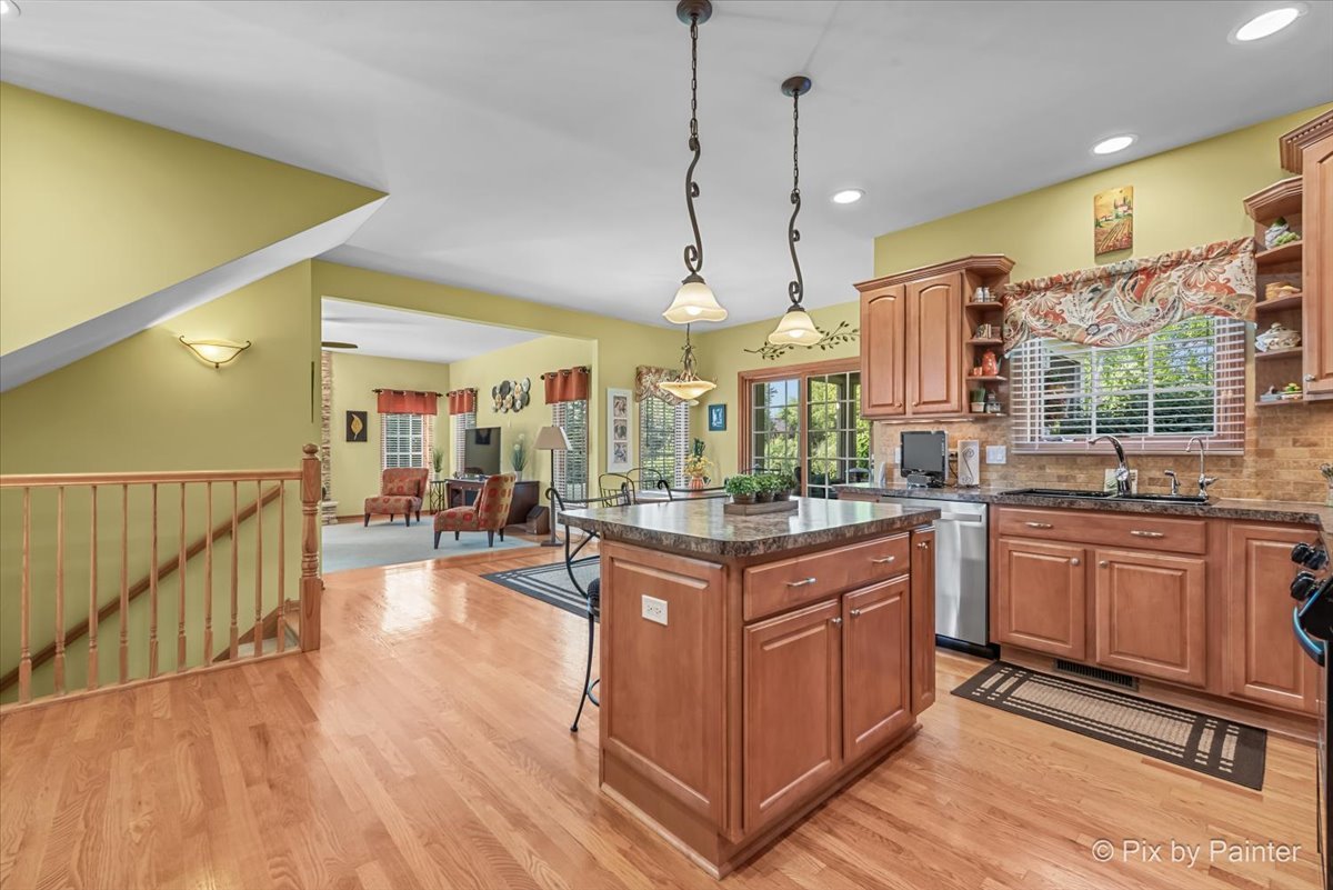 3720 Cypress Drive Spring Grove, IL 60071 - Photo 16 of 55 a kitchen with stainless steel appliances granite countertop a stove and a wooden floors