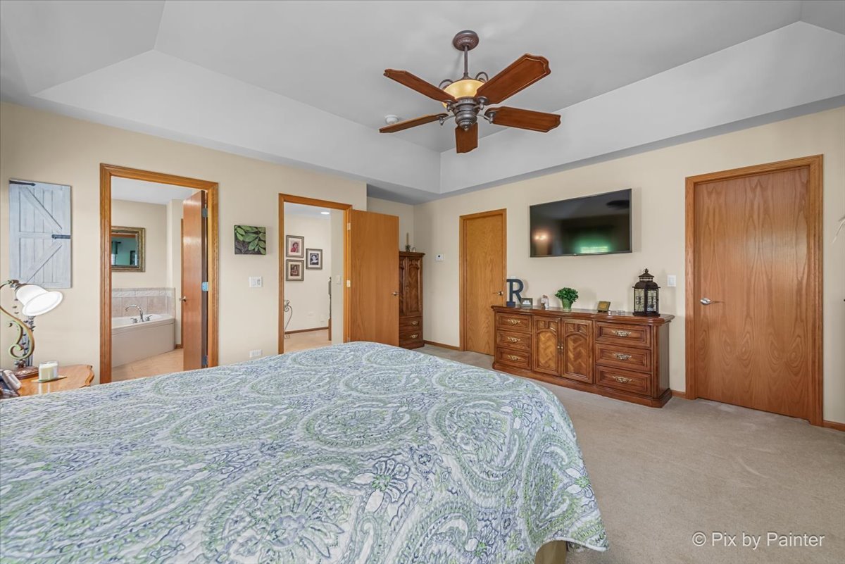 3720 Cypress Drive Spring Grove, IL 60071 - Photo 18 of 55 a bedroom with a bed and a flat screen tv