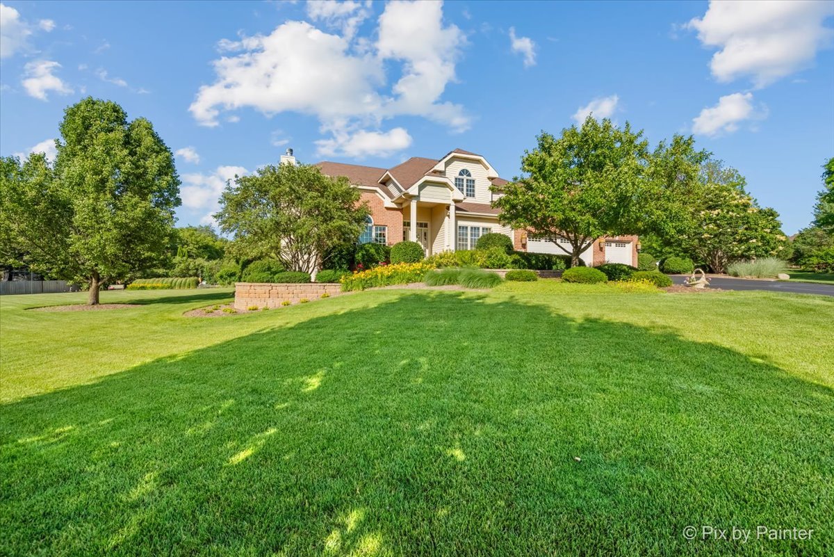 3720 Cypress Drive Spring Grove, IL 60071 - Photo 2 of 55 a view of a house with a big yard and large trees