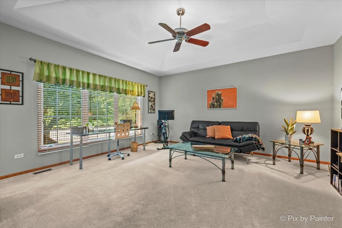 3720 Cypress Drive Spring Grove, IL 60071 - Photo 24 of 55 a living room with furniture a window and a flat screen tv