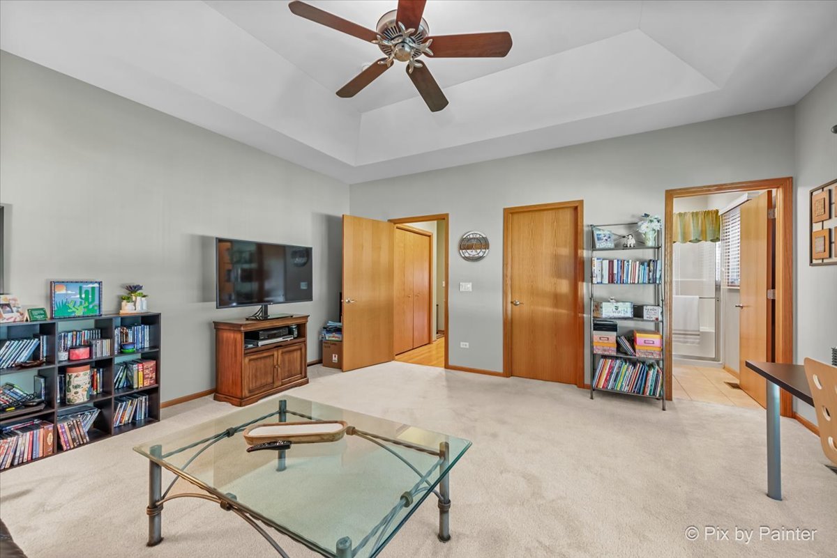 3720 Cypress Drive Spring Grove, IL 60071 - Photo 25 of 55 a living room with furniture a flat screen tv and a table