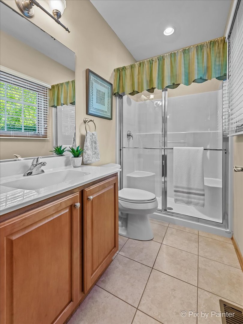 3720 Cypress Drive Spring Grove, IL 60071 - Photo 26 of 55 a bathroom with a granite countertop sink a toilet and shower