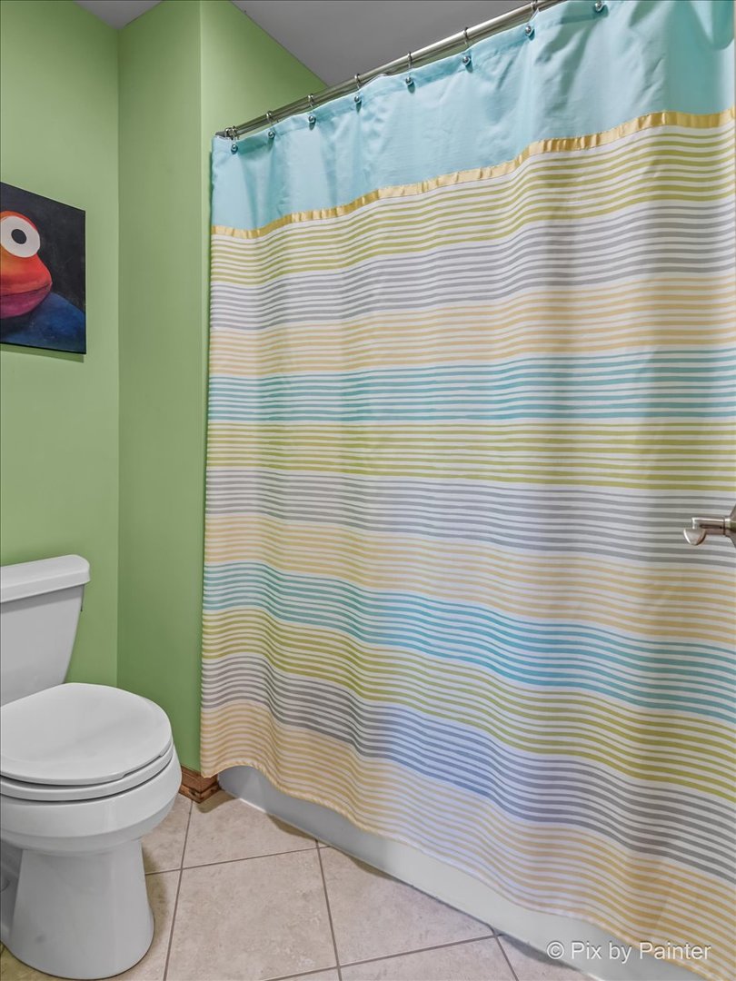 3720 Cypress Drive Spring Grove, IL 60071 - Photo 32 of 55 a bathroom with a toilet and a shower curtain