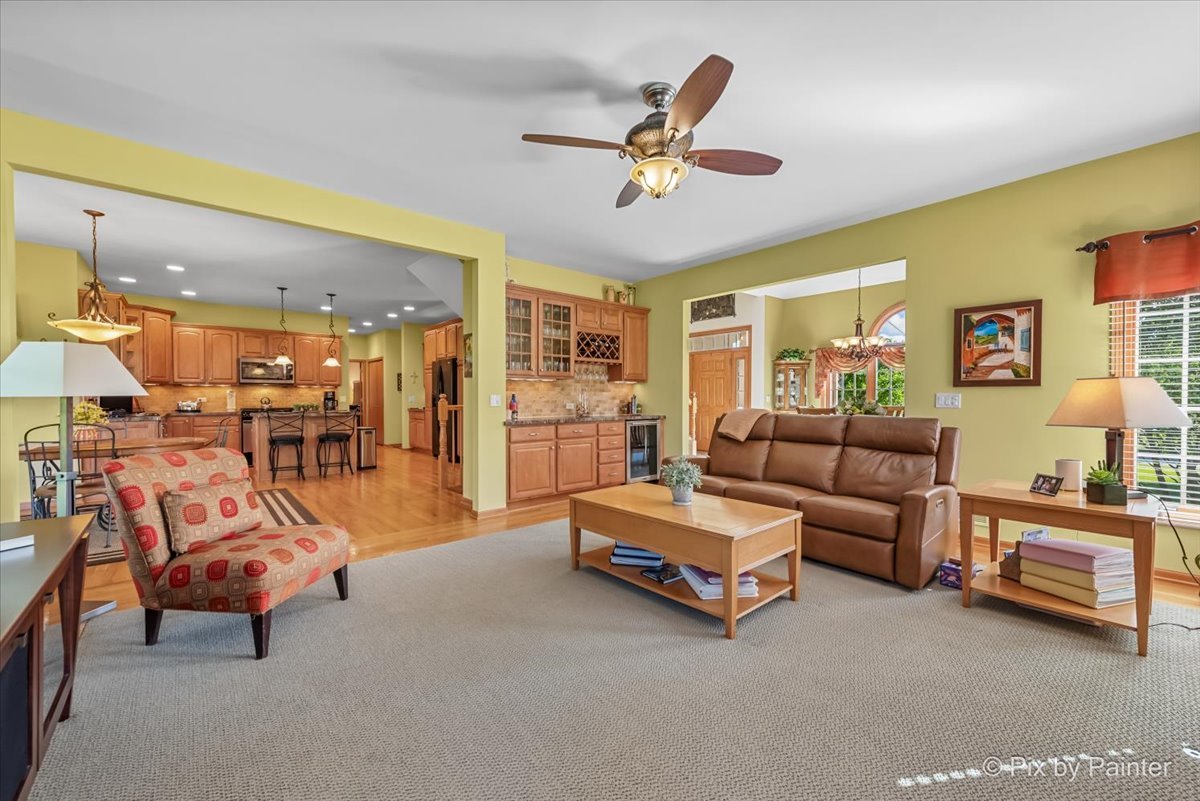 3720 Cypress Drive Spring Grove, IL 60071 - Photo 6 of 55 a living room with furniture and a chandelier